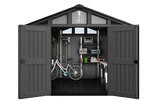 Cobertizo de jardín de plástico gris oscuro con puertas abiertas, mostrando una bicicleta, herramientas y estanterías en el